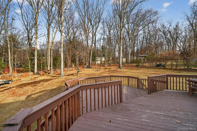 a view of balcony with wooden floor and fence