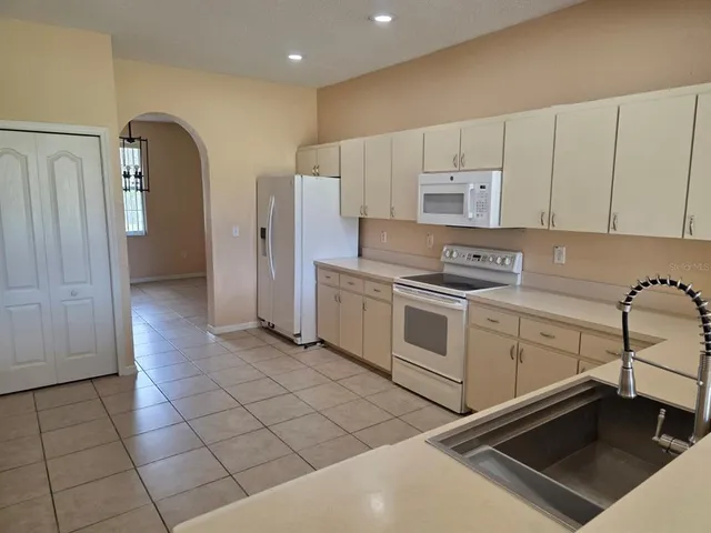 a kitchen with stainless steel appliances a stove a refrigerator and cabinets