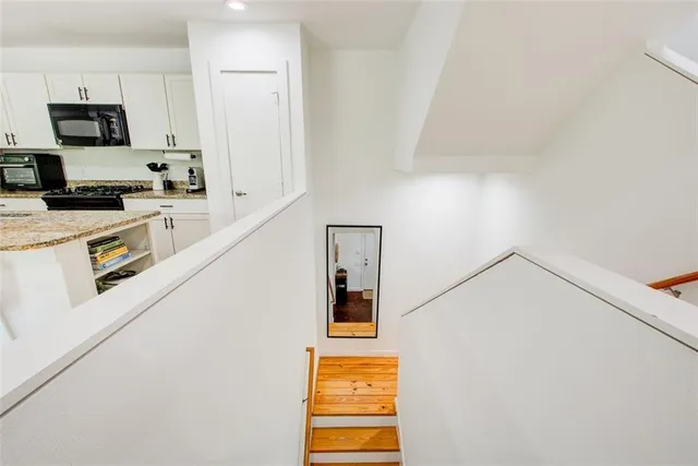 a kitchen with a refrigerator and a stove top oven