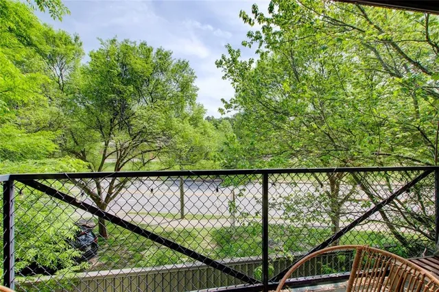 a view of a balcony next to a yard