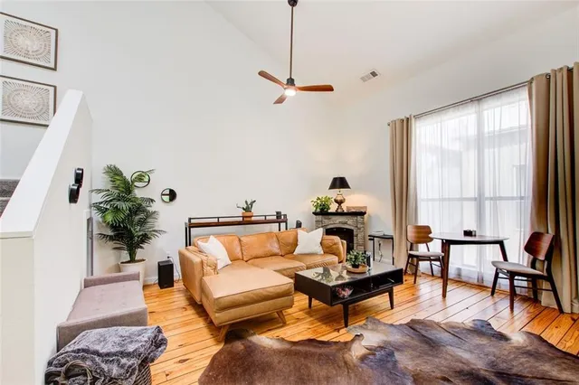 a living room with furniture a large window and a flat screen tv