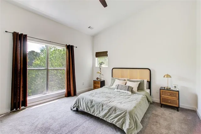 a bedroom with a large bed and a large window