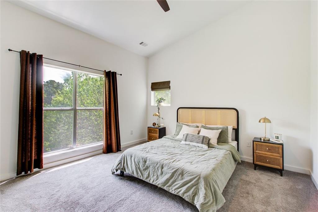 241 Maynard Terrace Southeast, Unit 7 Atlanta, GA 30316 - Photo 27 of 44 a bedroom with a bed and large window