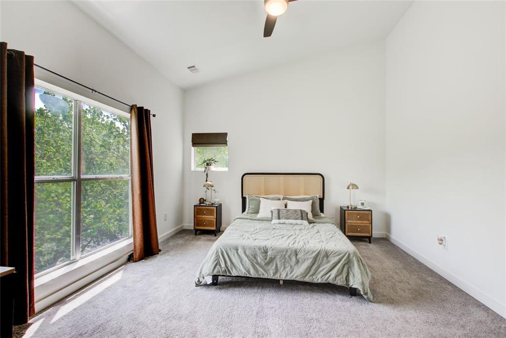 241 Maynard Terrace Southeast, Unit 7 Atlanta, GA 30316 - Photo 28 of 44 a bedroom with a large bed and a large window