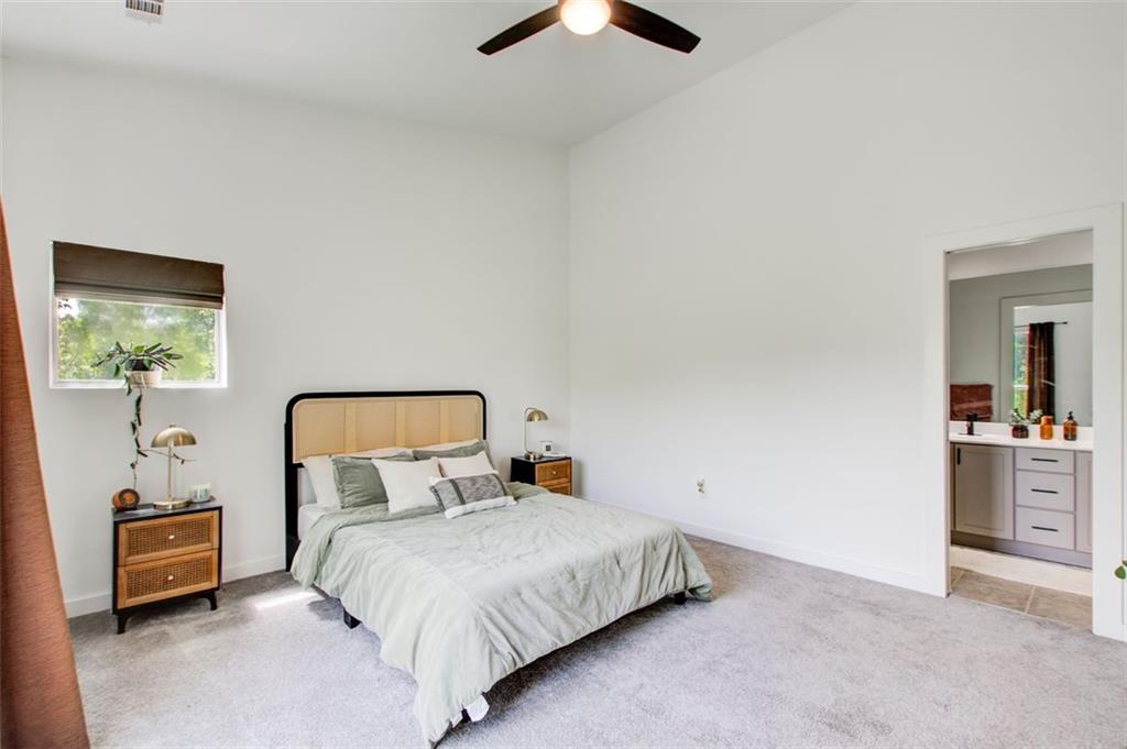 241 Maynard Terrace Southeast, Unit 7 Atlanta, GA 30316 - Photo 29 of 44 a bedroom with a bed and a chandelier