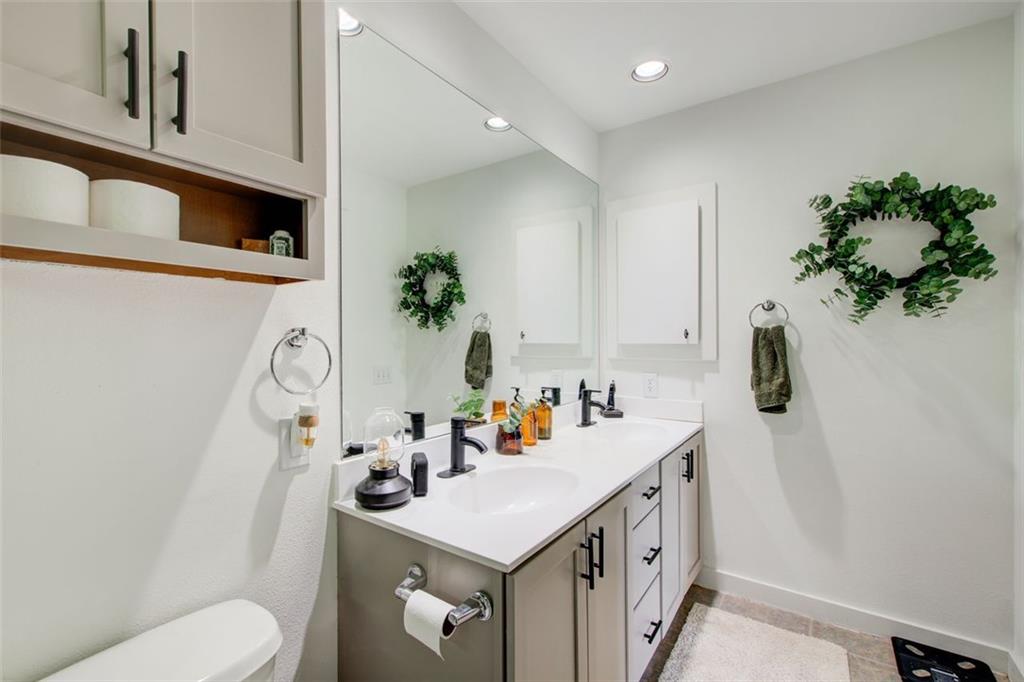 241 Maynard Terrace Southeast, Unit 7 Atlanta, GA 30316 - Photo 32 of 44 a bathroom with a sink a toilet and a mirror