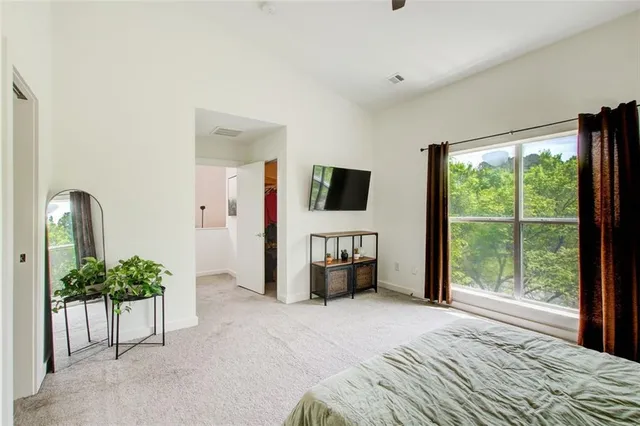 a view of a bedroom with clothes and shoes