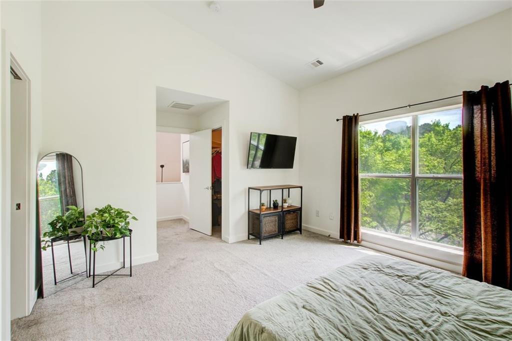 241 Maynard Terrace Southeast, Unit 7 Atlanta, GA 30316 - Photo 33 of 44 a bedroom with a bed and a television