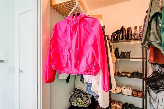 a backyard of a house with plants and trees with wooden fence