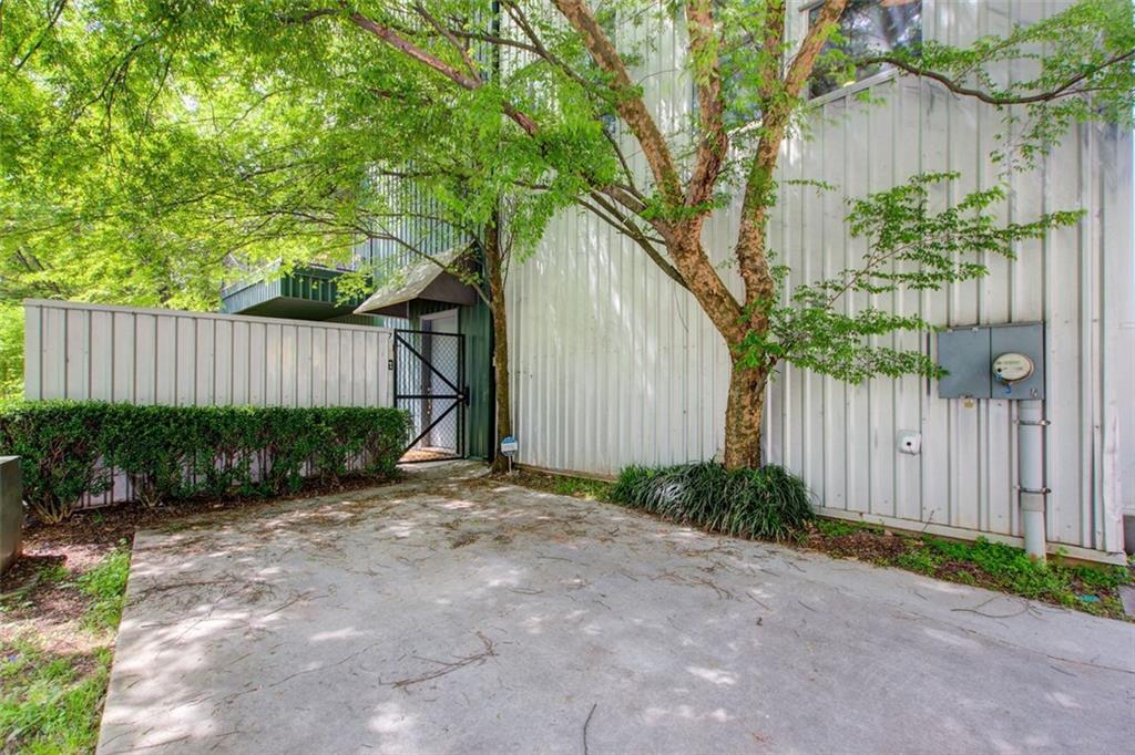 241 Maynard Terrace Southeast, Unit 7 Atlanta, GA 30316 - Photo 36 of 44 a backyard of a house with plants and trees with wooden fence