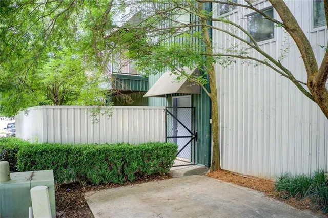 a view of a backyard with a chair and potted plant