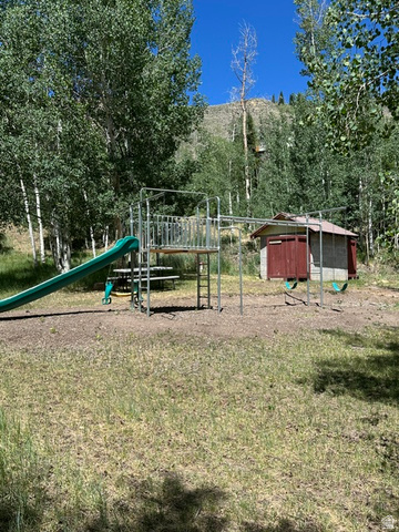 1085 West Elk Road Helper, UT 84526 - Photo 40 of 40 Outdoor recreation area featuring a multi-level play structure with a green slide, swing set, and picnic table