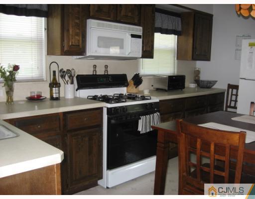 13 Sine Road Edison, NJ 08817 - Photo 3 of 10 a kitchen with a sink and a stove top oven