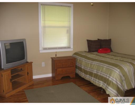 13 Sine Road Edison, NJ 08817 - Photo 4 of 10 a bedroom with a bed and a flat screen tv