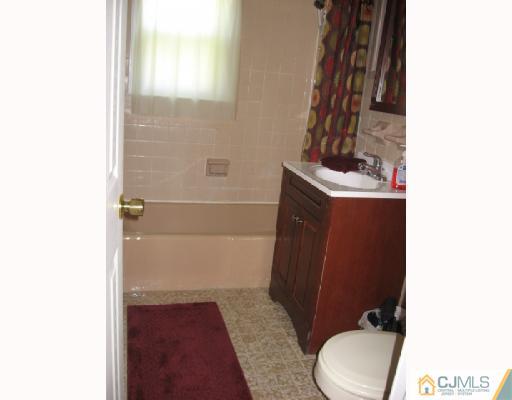 13 Sine Road Edison, NJ 08817 - Photo 10 of 10 a bathroom with a sink and a toilet
