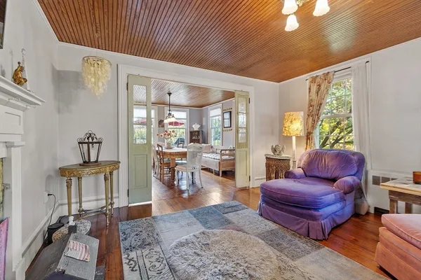 a living room with furniture a rug and a large window