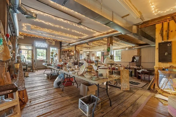 a view of a dining hall with lots of wooden furniture