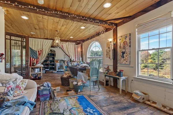 a living room with patio furniture and a large window