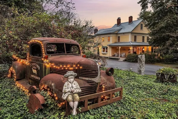 a front view of a house with a garden and parking space