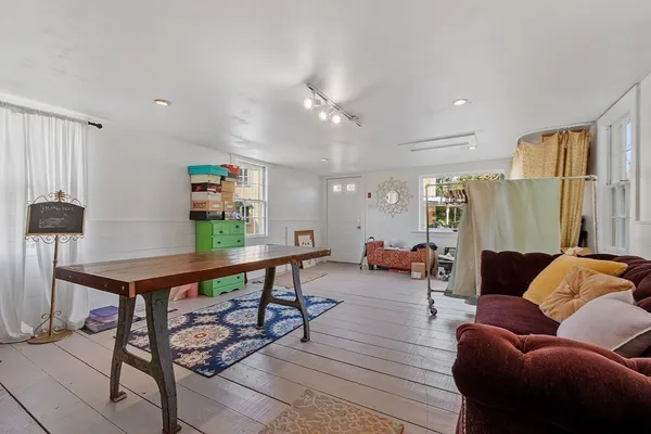 a living room with furniture a rug and a chandelier
