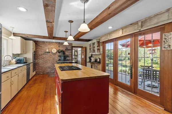 a kitchen with stainless steel appliances granite countertop sink stove and large window