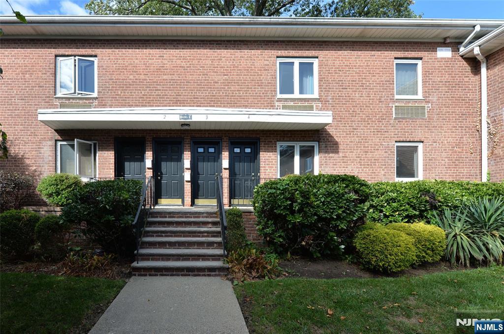 250 Oak Street, Unit E4 Ridgewood, NJ 07450 - Photo 2 of 12 a view of a house with a yard and plants