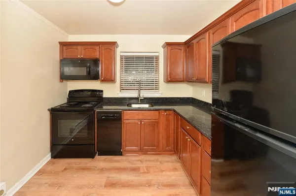 a kitchen with granite countertop a stove and a sink