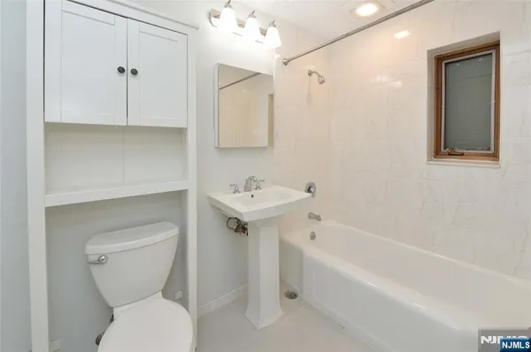 a bathroom with a toilet sink and bathtub