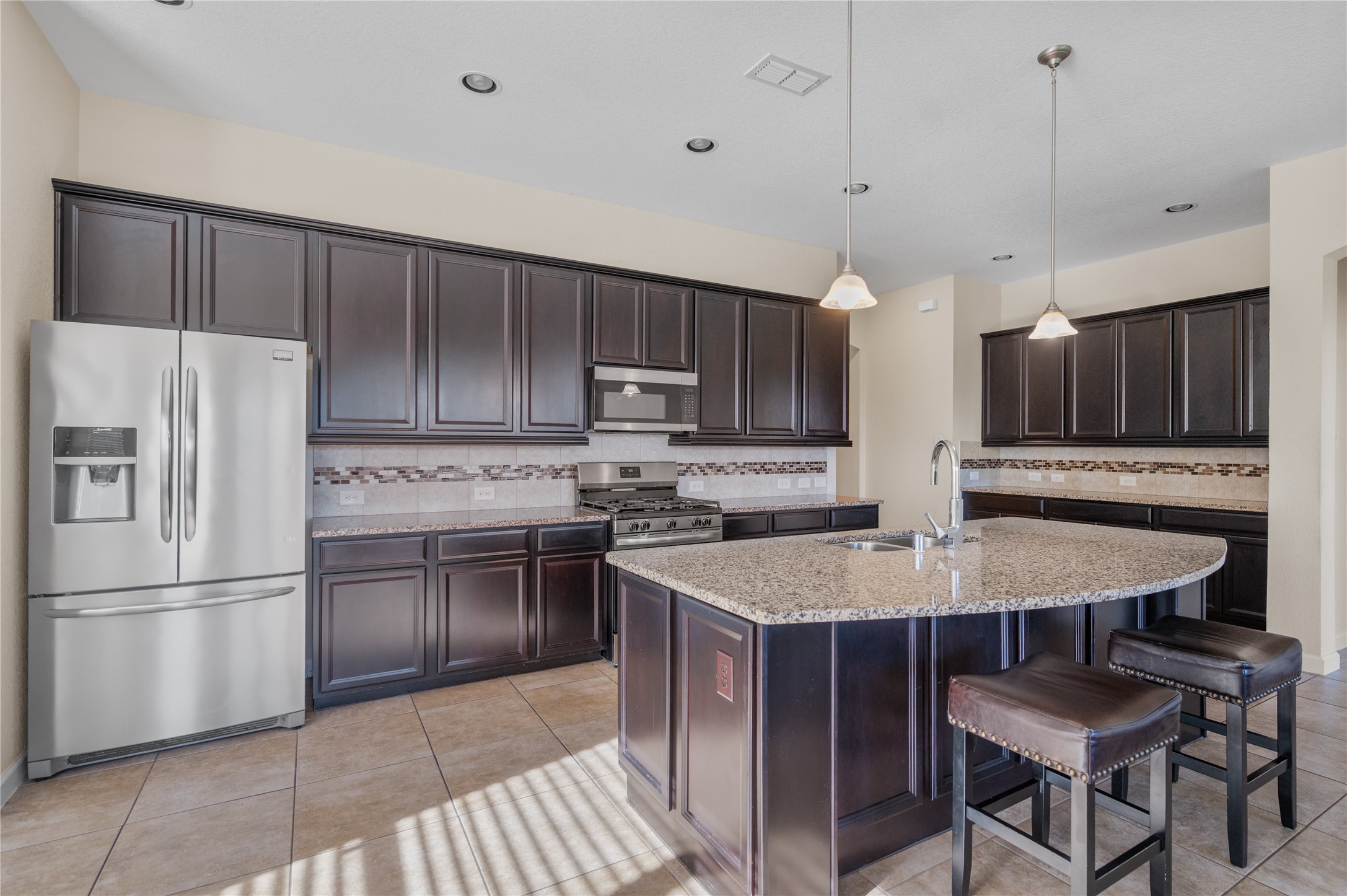 9430 Jayci Hills Lane Cypress, TX 77433 - Photo 1 of 28 a kitchen with stainless steel appliances granite countertop a refrigerator a stove a sink dishwasher a dining table and chairs