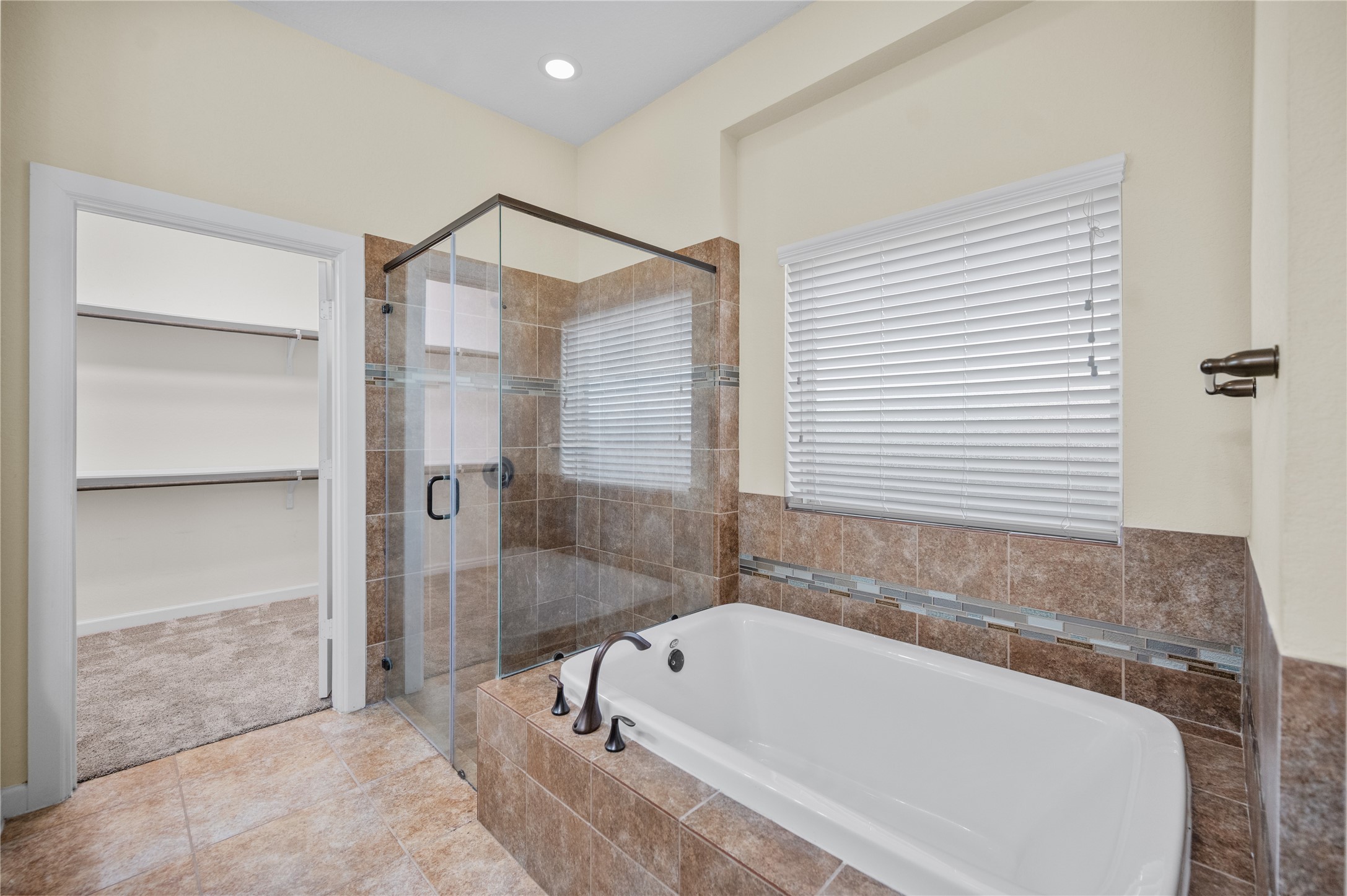 9430 Jayci Hills Lane Cypress, TX 77433 - Photo 18 of 28 a bathroom with a tub and a shower