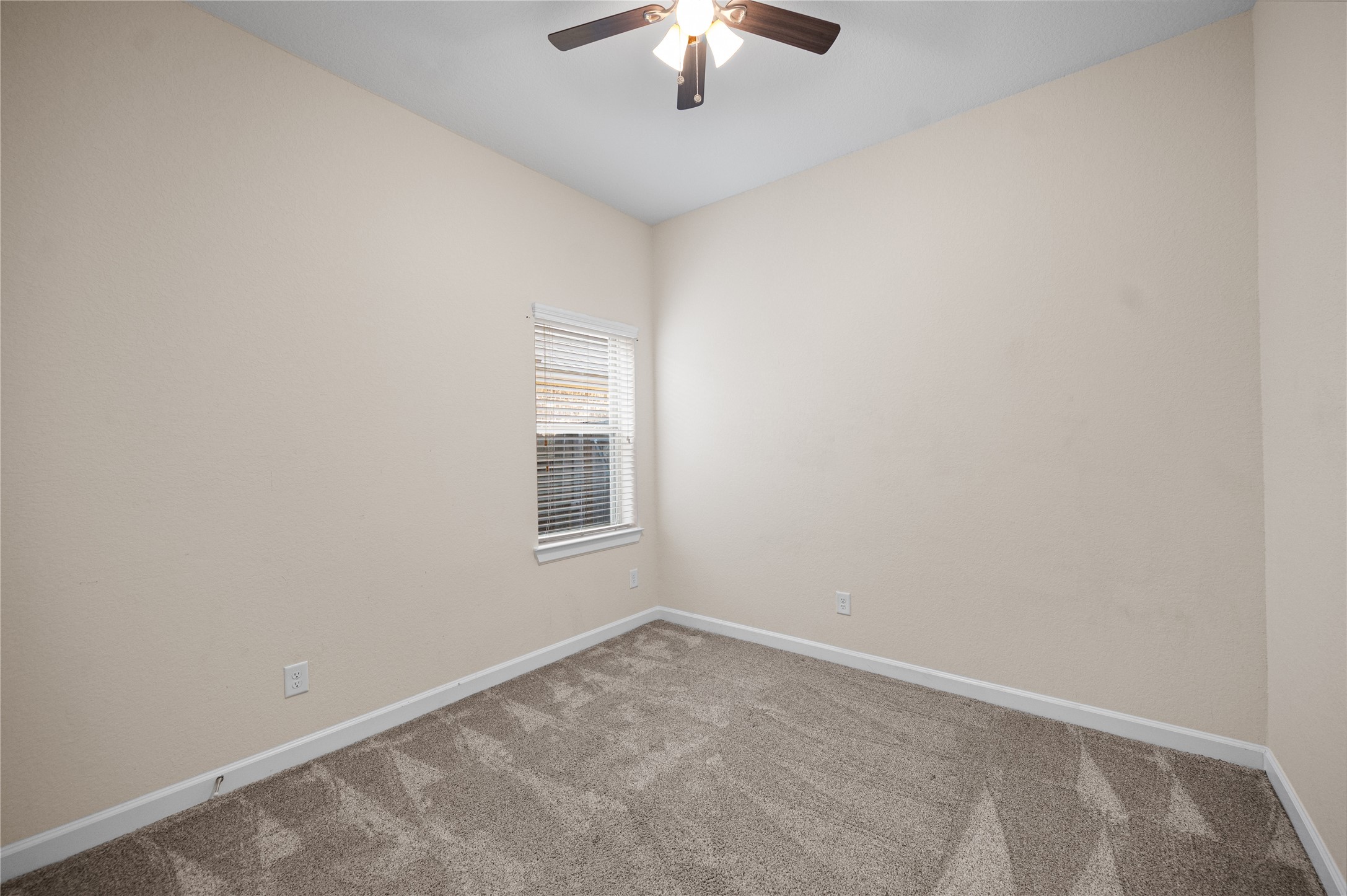 9430 Jayci Hills Lane Cypress, TX 77433 - Photo 22 of 28 an empty room with a chandelier fan