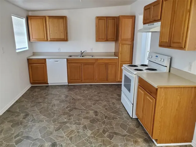 a utility room with a sink a washer and dryer