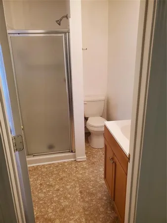 a bathroom with a toilet and a shower