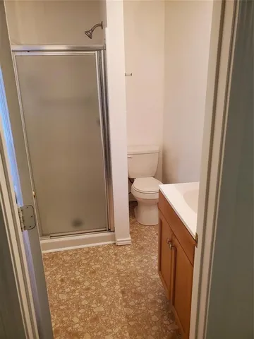 a bathroom with a toilet and a shower