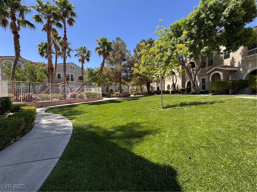 9975 Peace Way, Unit 1140 Las Vegas, NV 89147 - Photo 22 of 23 View of property's community featuring fence and a yard