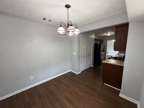 a view of a kitchen with wooden floor and a chandelier