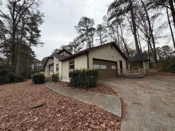 a front view of a house with a yard covered outdoor seating and pathway