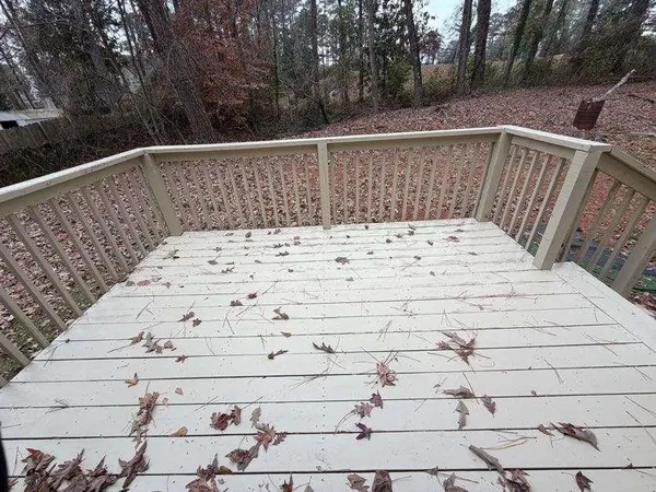 a view of wooden roof with trees in the background