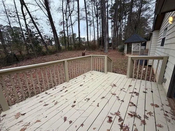 a view of balcony with wooden floor and fence