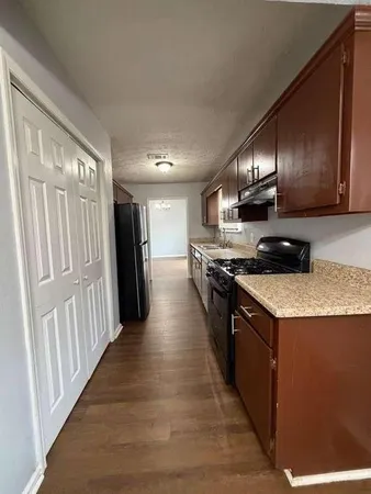 a kitchen with granite countertop a sink and stainless steel appliances