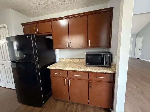 a kitchen with a refrigerator and a sink