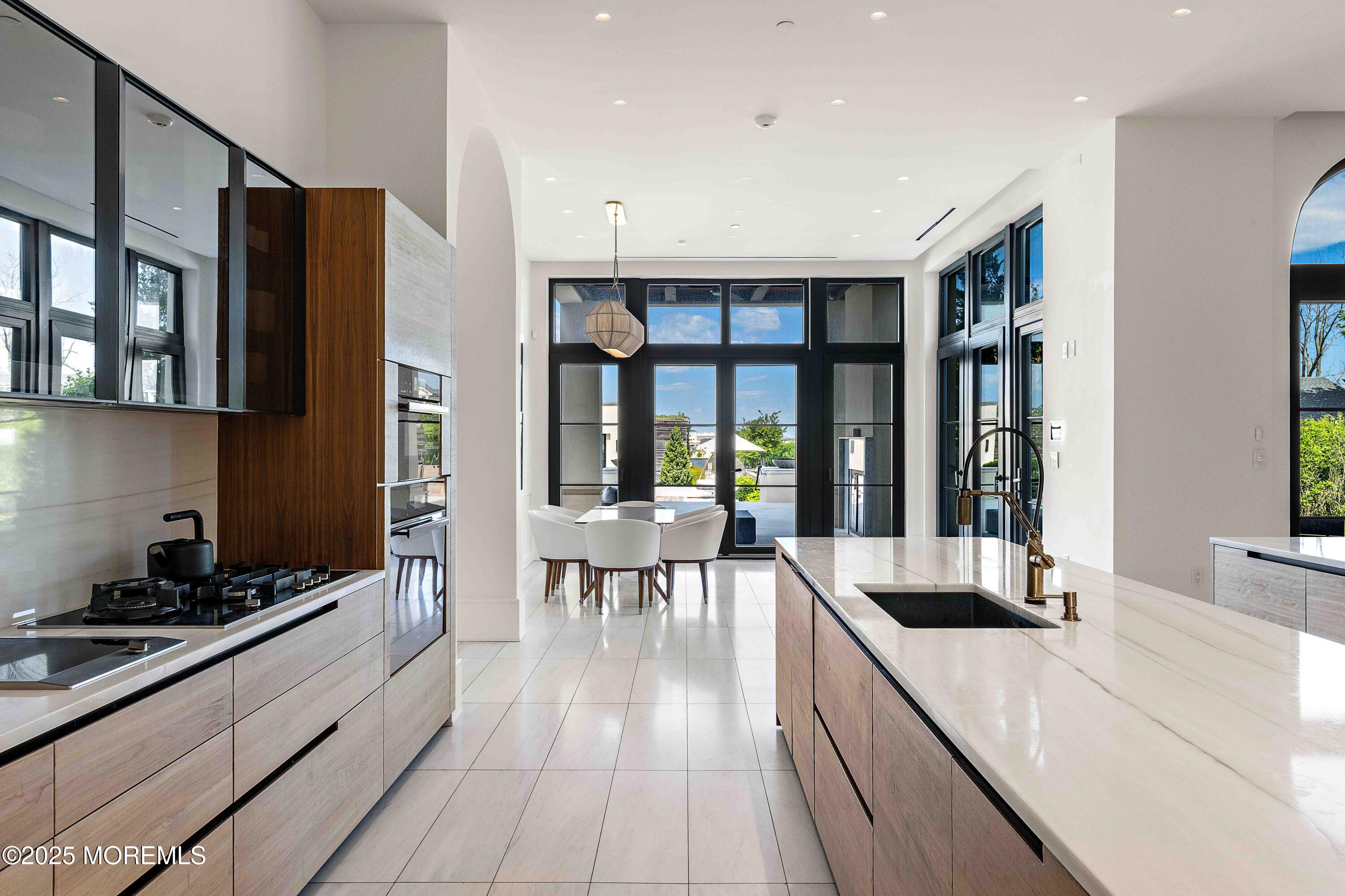 27 Ward Avenue Rumson, NJ 07760 - Photo 14 of 71 a large kitchen with a large window and stainless steel appliances