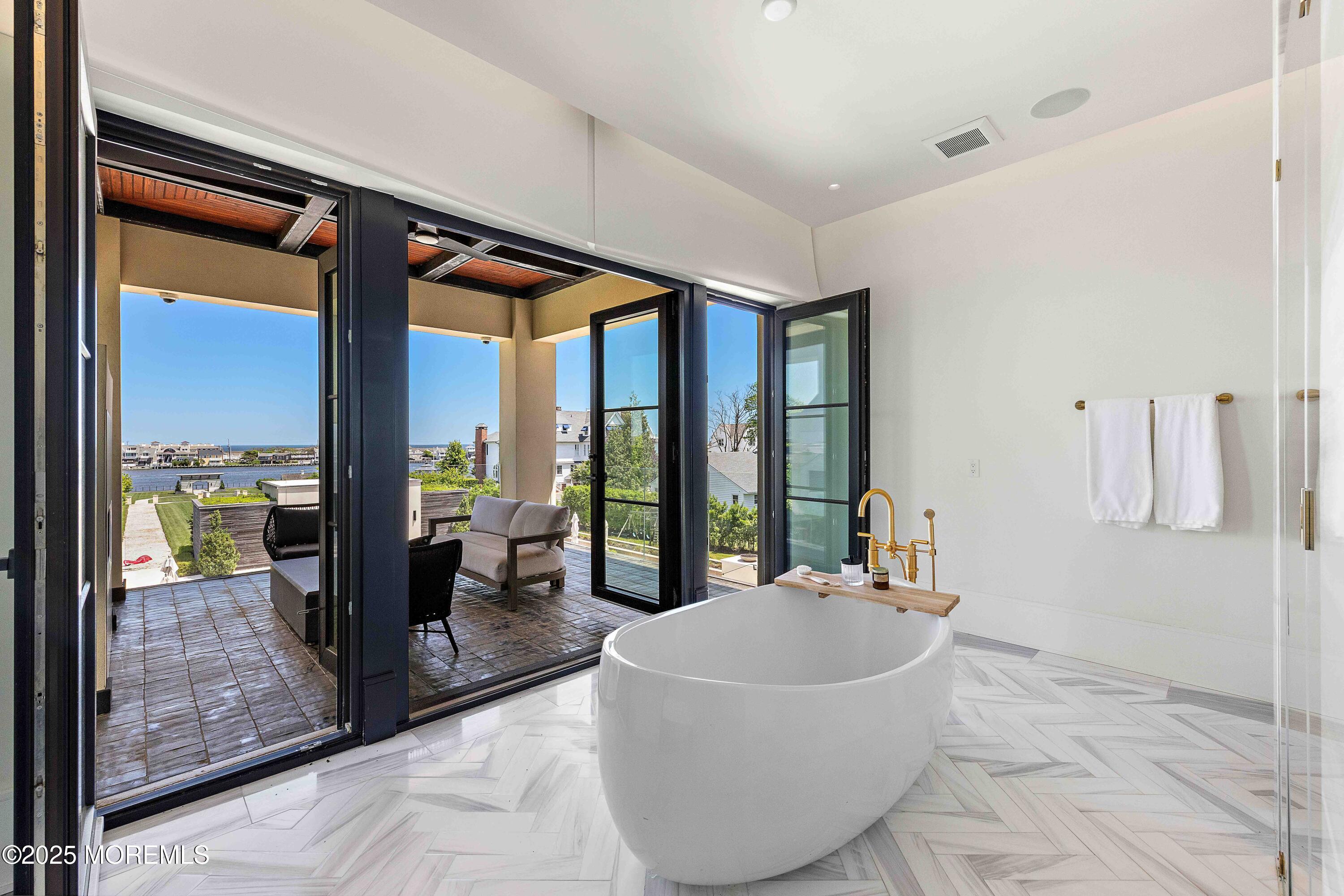 27 Ward Avenue Rumson, NJ 07760 - Photo 29 of 71 a spacious bathroom with a tub and large windows