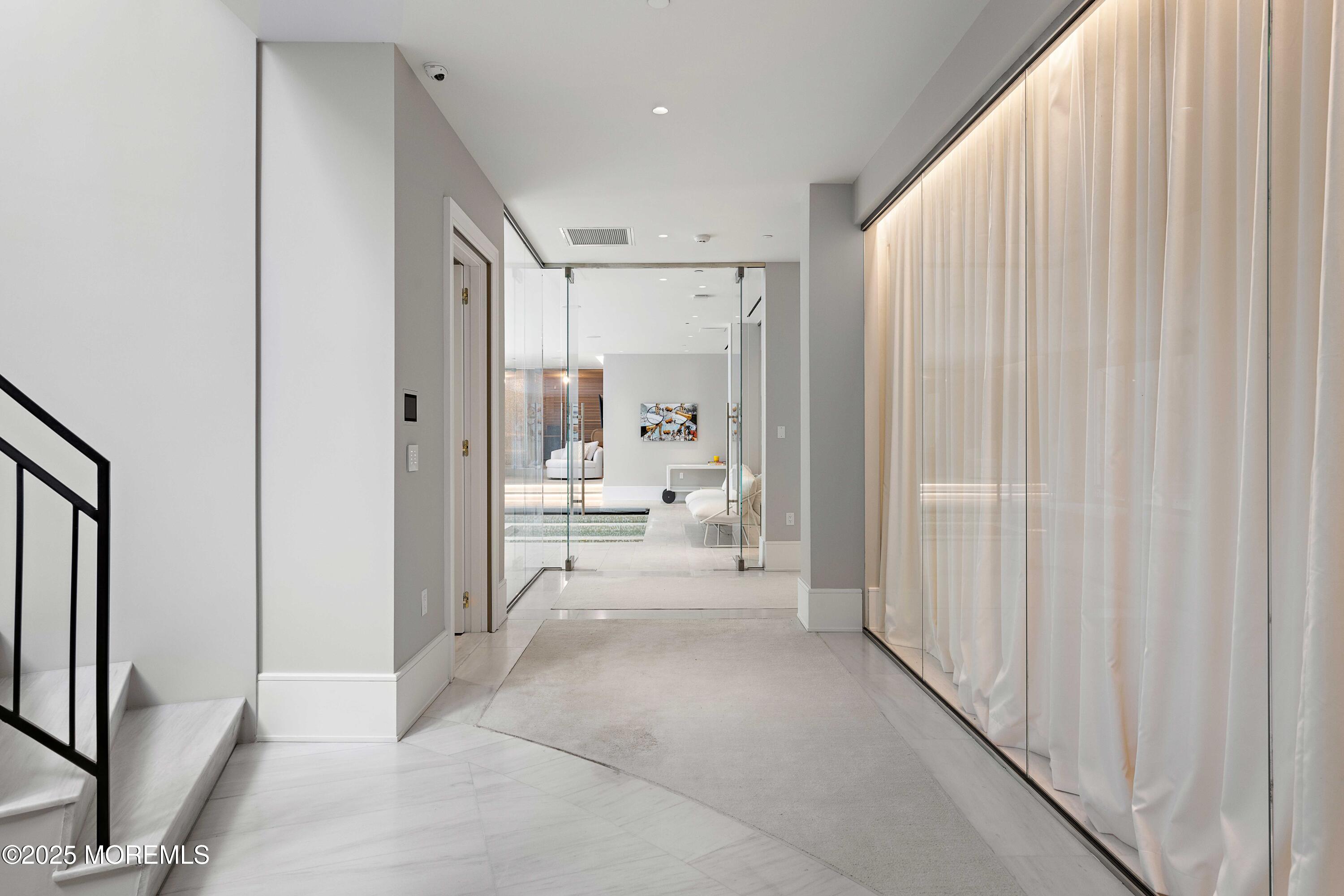 27 Ward Avenue Rumson, NJ 07760 - Photo 47 of 71 a view of a hallway with a livingroom and a bathroom