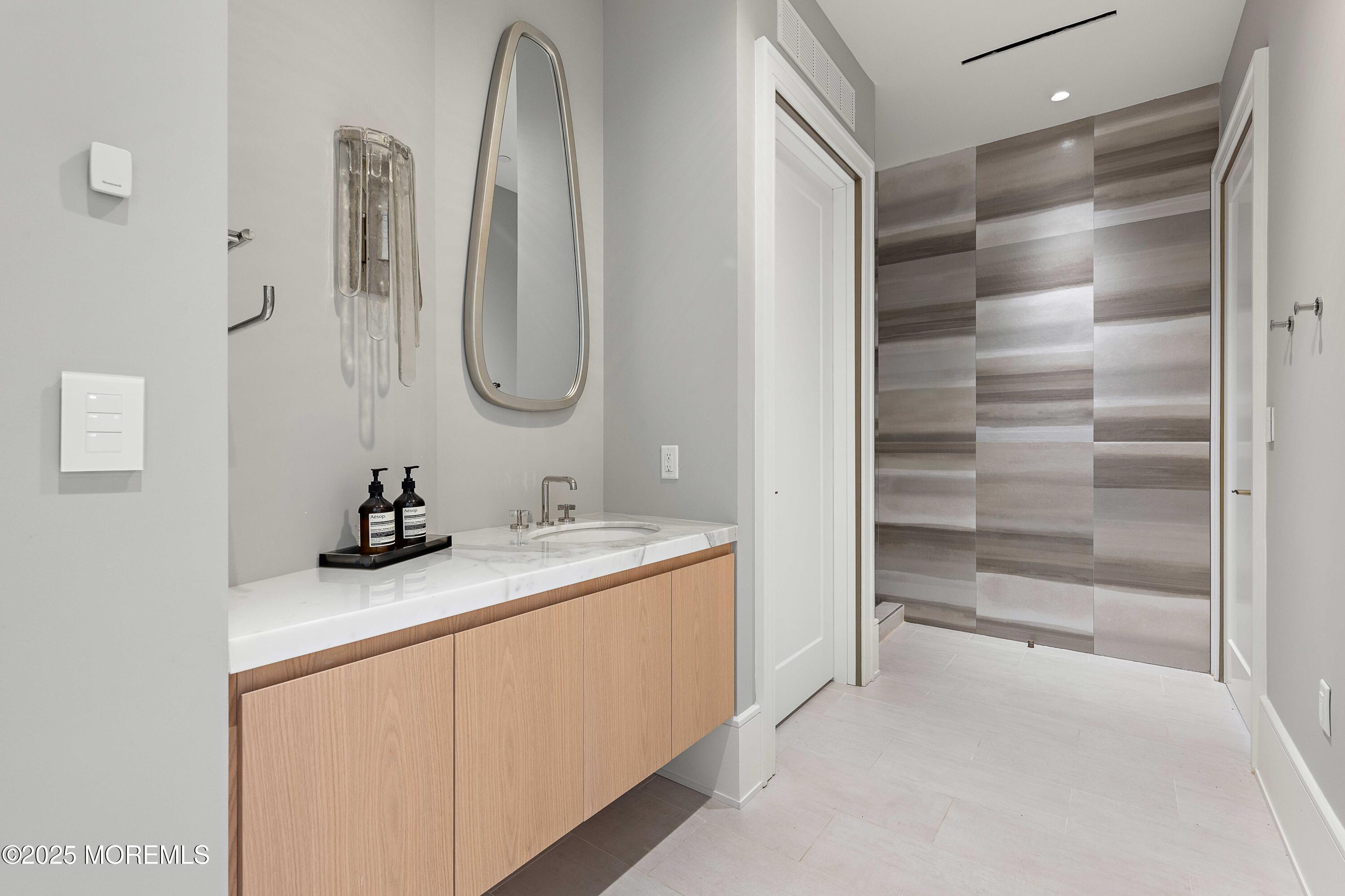 27 Ward Avenue Rumson, NJ 07760 - Photo 48 of 71 a bathroom with a granite countertop sink and a mirror