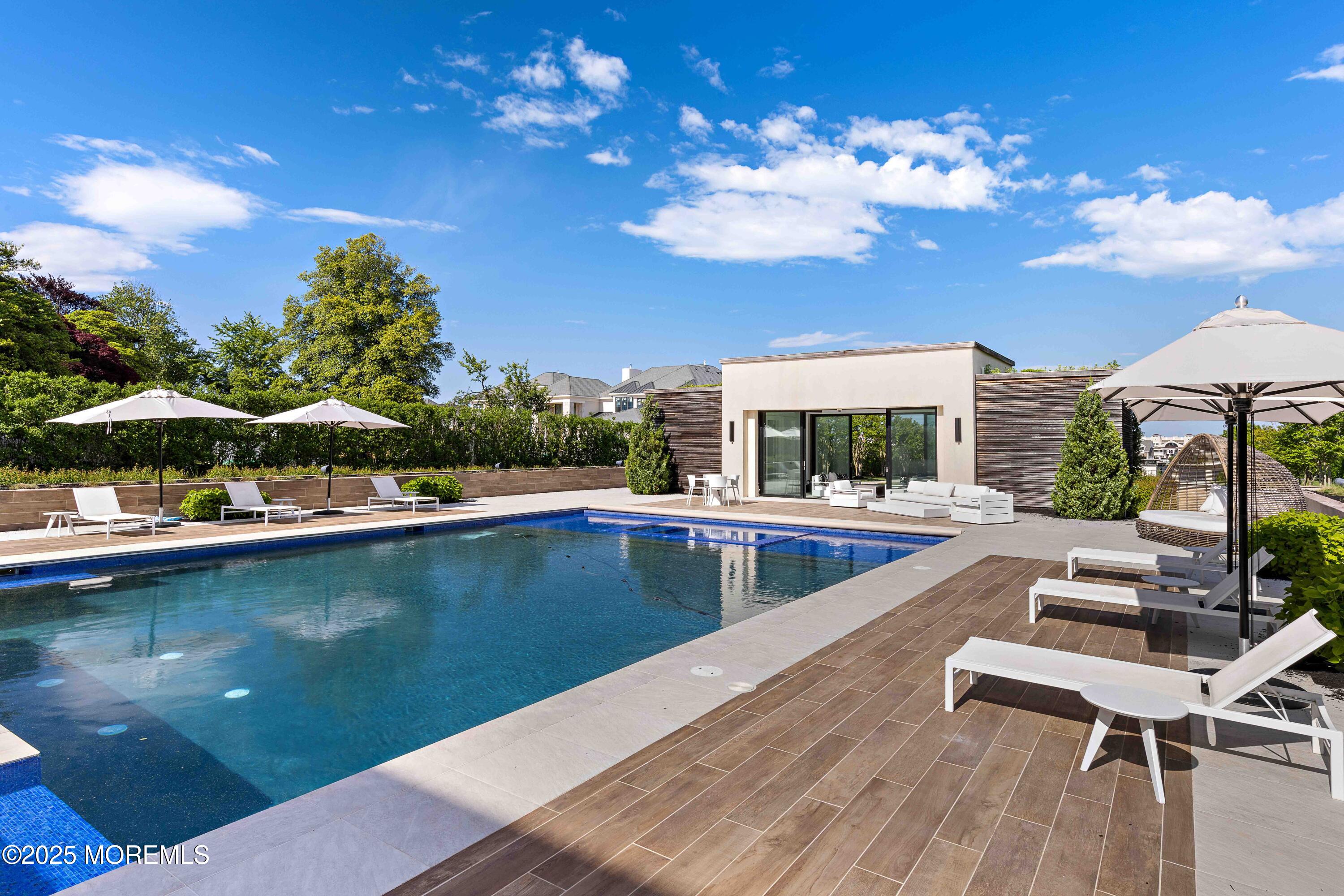 27 Ward Avenue Rumson, NJ 07760 - Photo 55 of 71 a view of a swimming pool with lounge chair