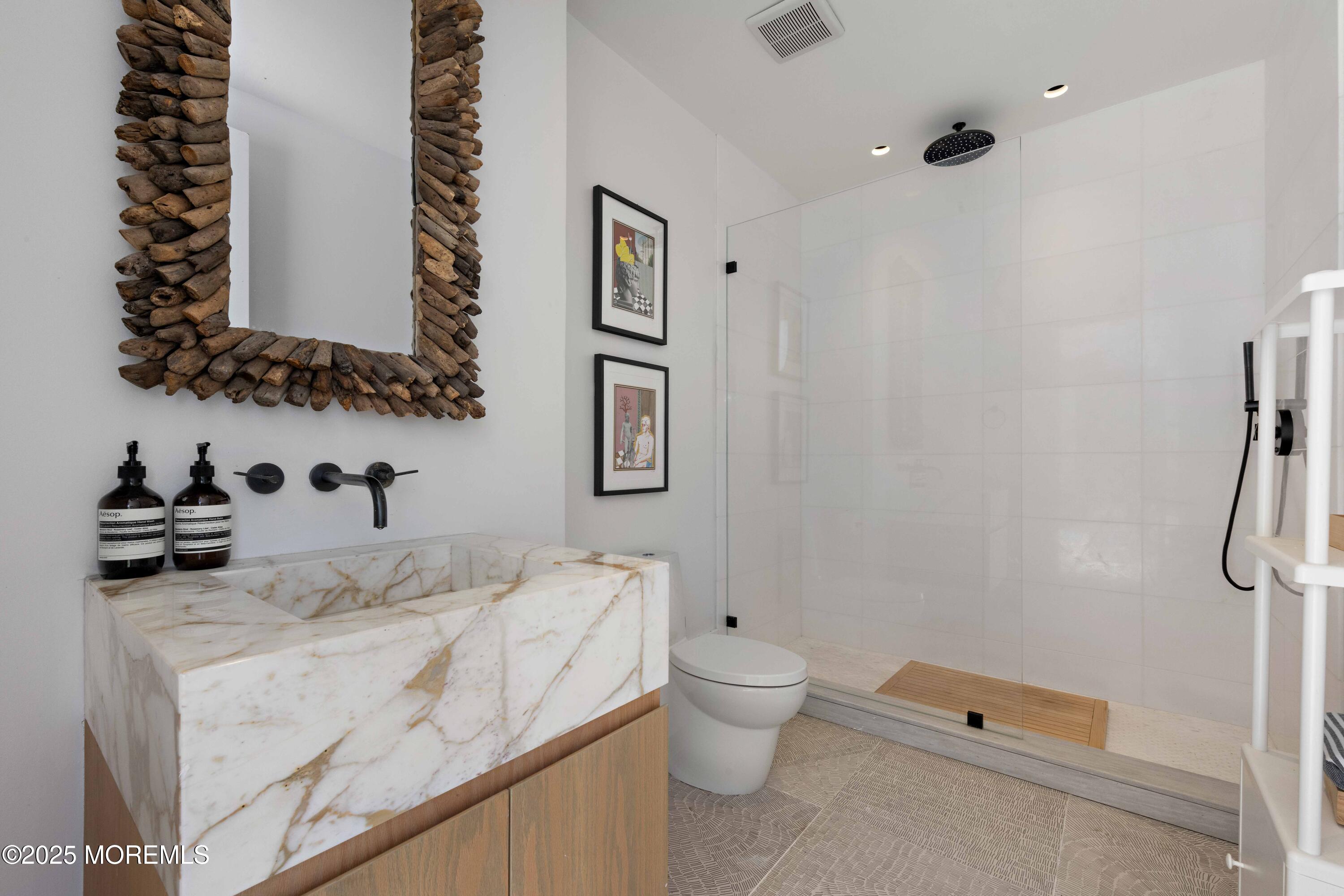 27 Ward Avenue Rumson, NJ 07760 - Photo 61 of 71 a bathroom with a granite countertop sink mirror vanity and toilet