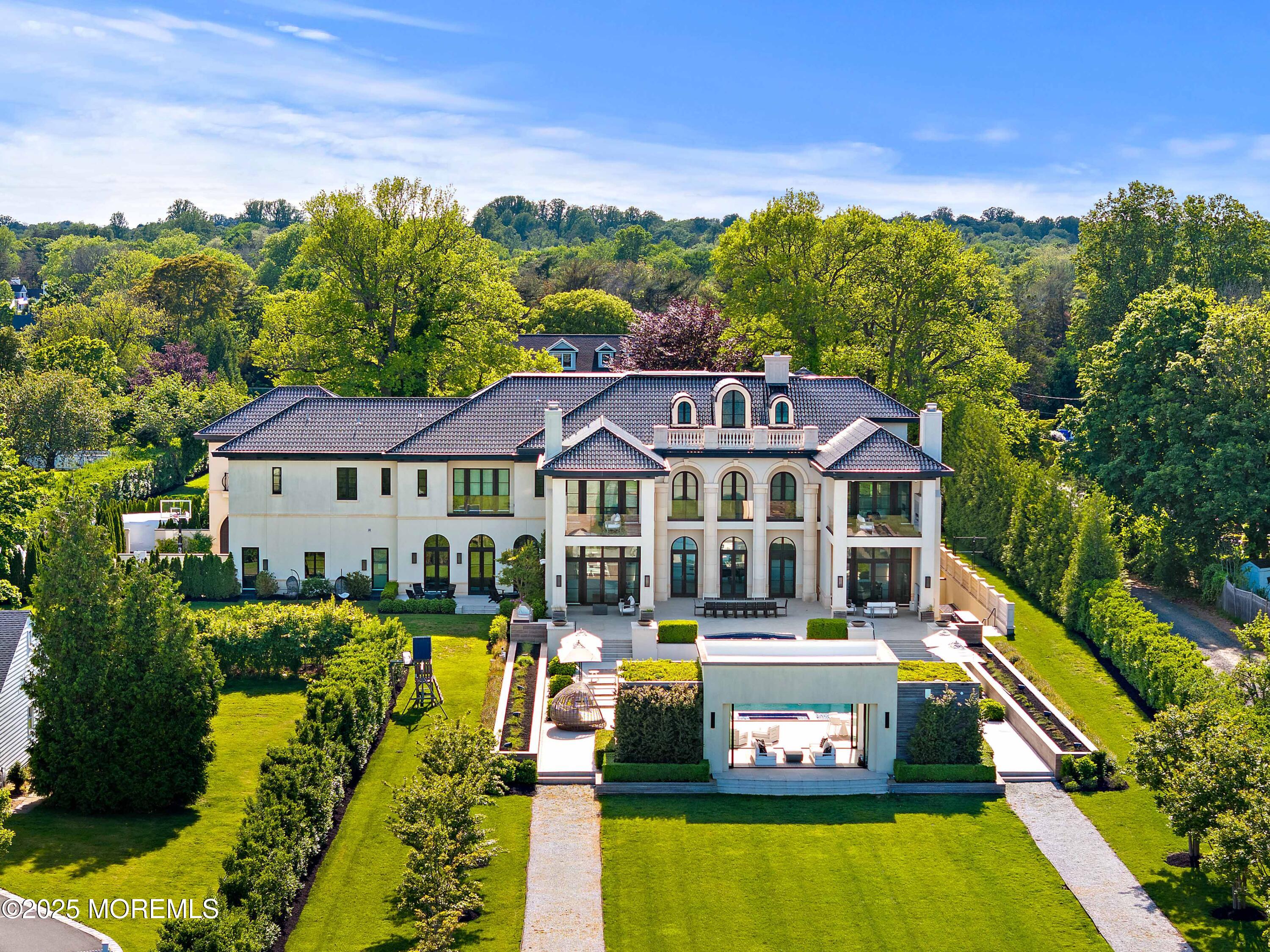 27 Ward Avenue Rumson, NJ 07760 - Photo 67 of 71 a view of a white house with a big yard and potted plants