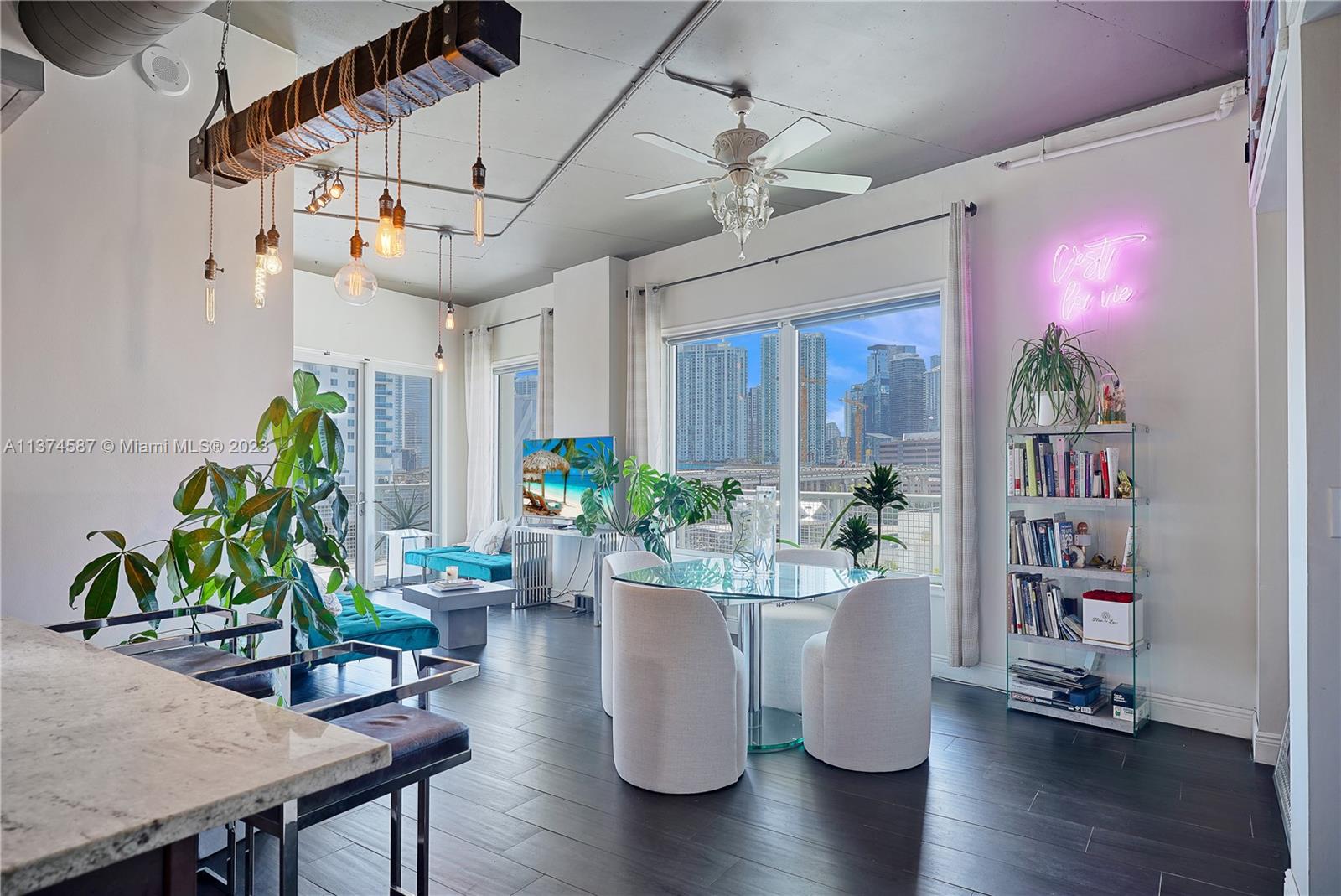 10 Southwest South River Drive, Unit 703 Miami, FL 33130 - Photo 11 of 47 a room with wooden floor table and chairs