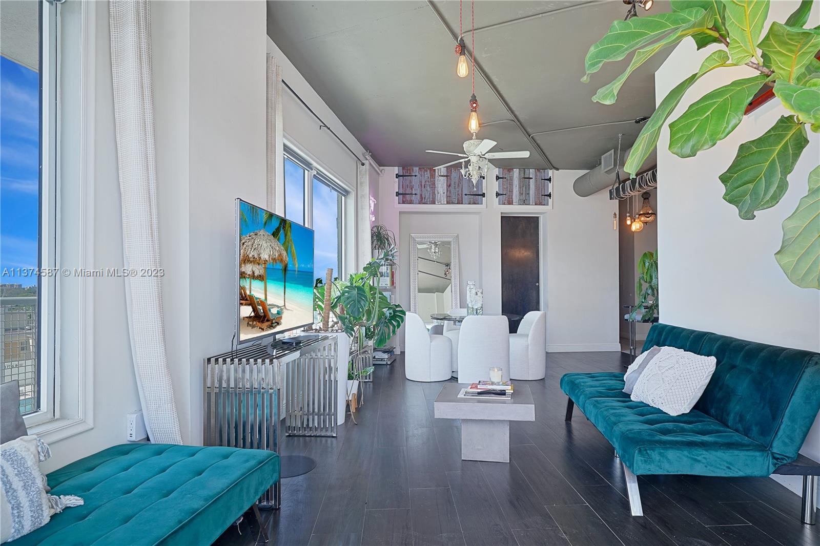 10 Southwest South River Drive, Unit 703 Miami, FL 33130 - Photo 17 of 47 a living room with furniture and a floor to ceiling window